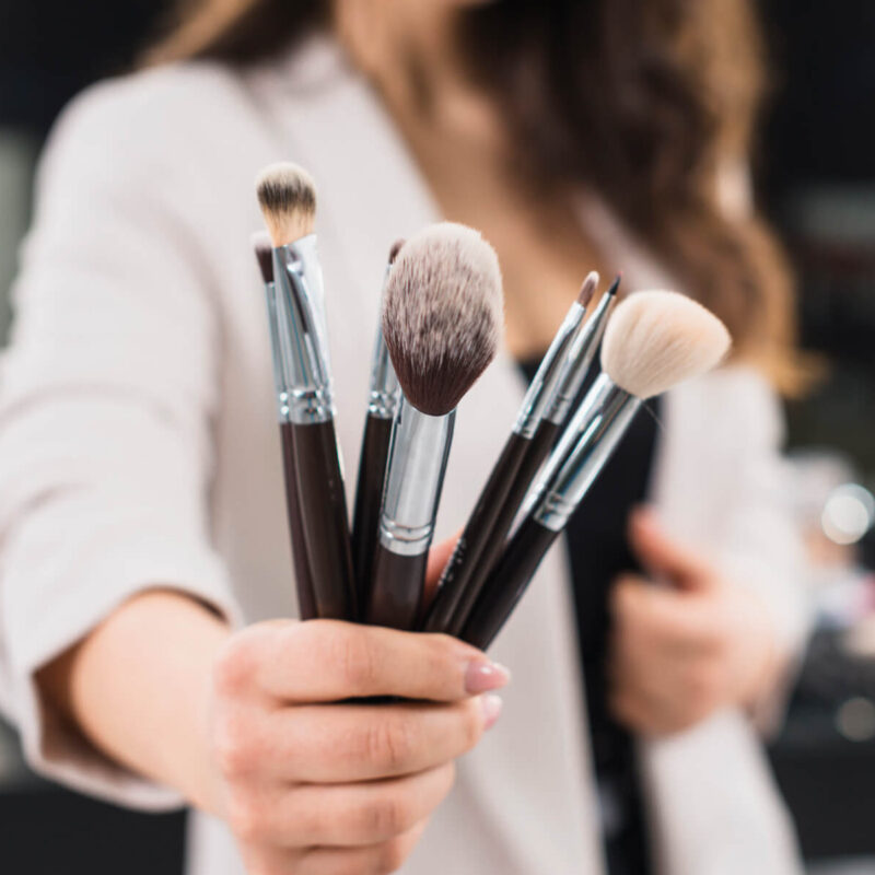 woman-hand-with-makeup-brushes